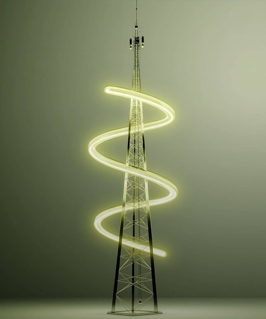 A cellphone tower stands wrapped by a glowing beam of light